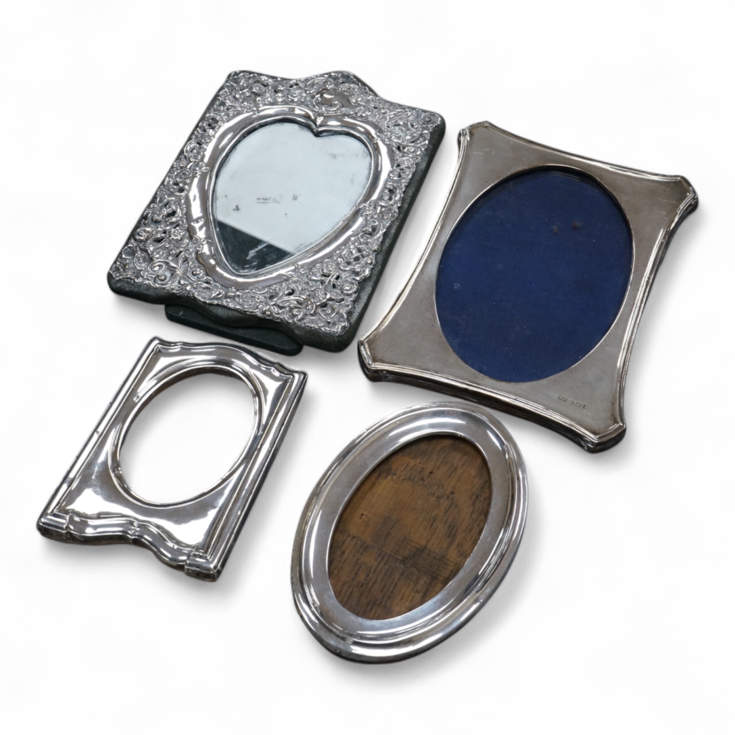 Four assorted early 20th century silver mounted photograph frames, the largest with pierced decoration, Chester, 1902, 19.5cm.